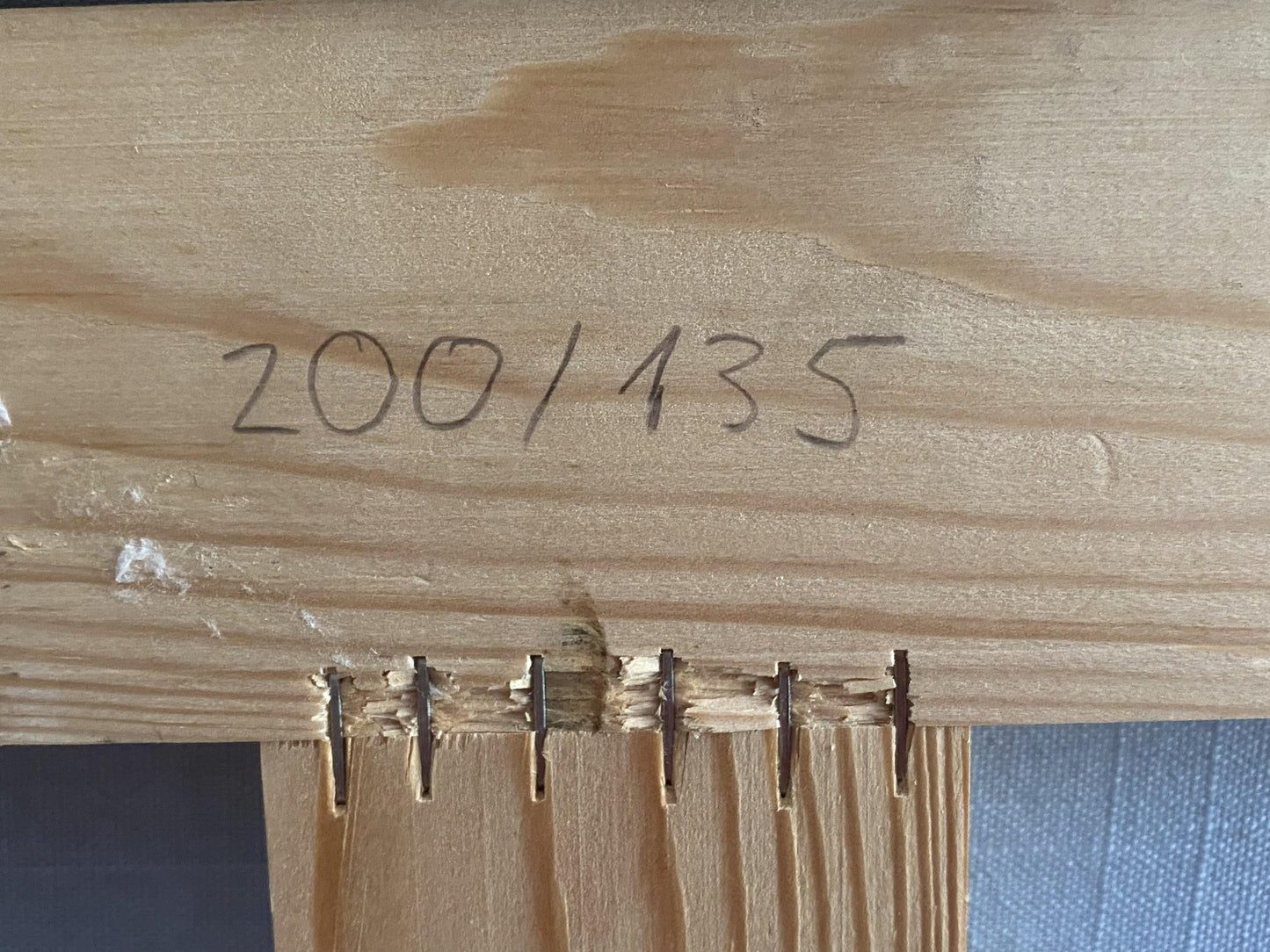 Back of Oil painting Alushta city: light wood beam marked 200/135 with 5 metal fasteners
