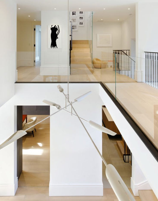 Sleek minimalist sculpture with metallic arms and white shades for interior design.