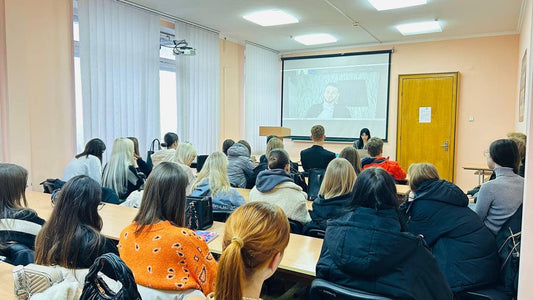 Woman inspiring next generation of art entrepreneurs in auditorium