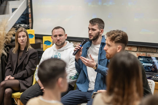 Man in blue jacket with black mic speaks at Ukrainian Vintage Co event on CtrlShyft