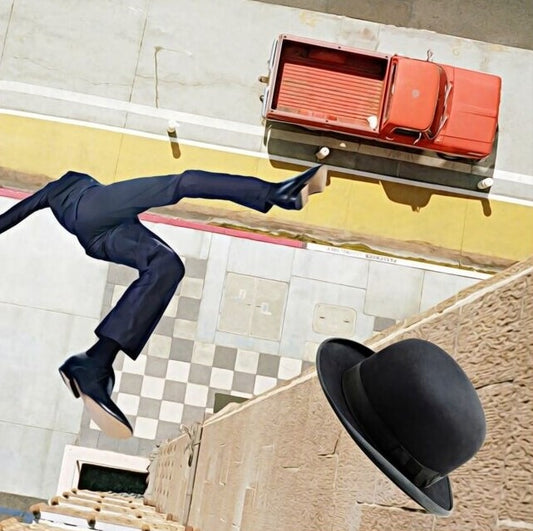 Glossy black bowler hat with curved brim in Surrealism art.