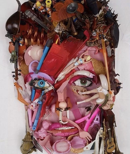 Vibrant pink red face sculpture from discarded objects in Art and Ecology exhibit