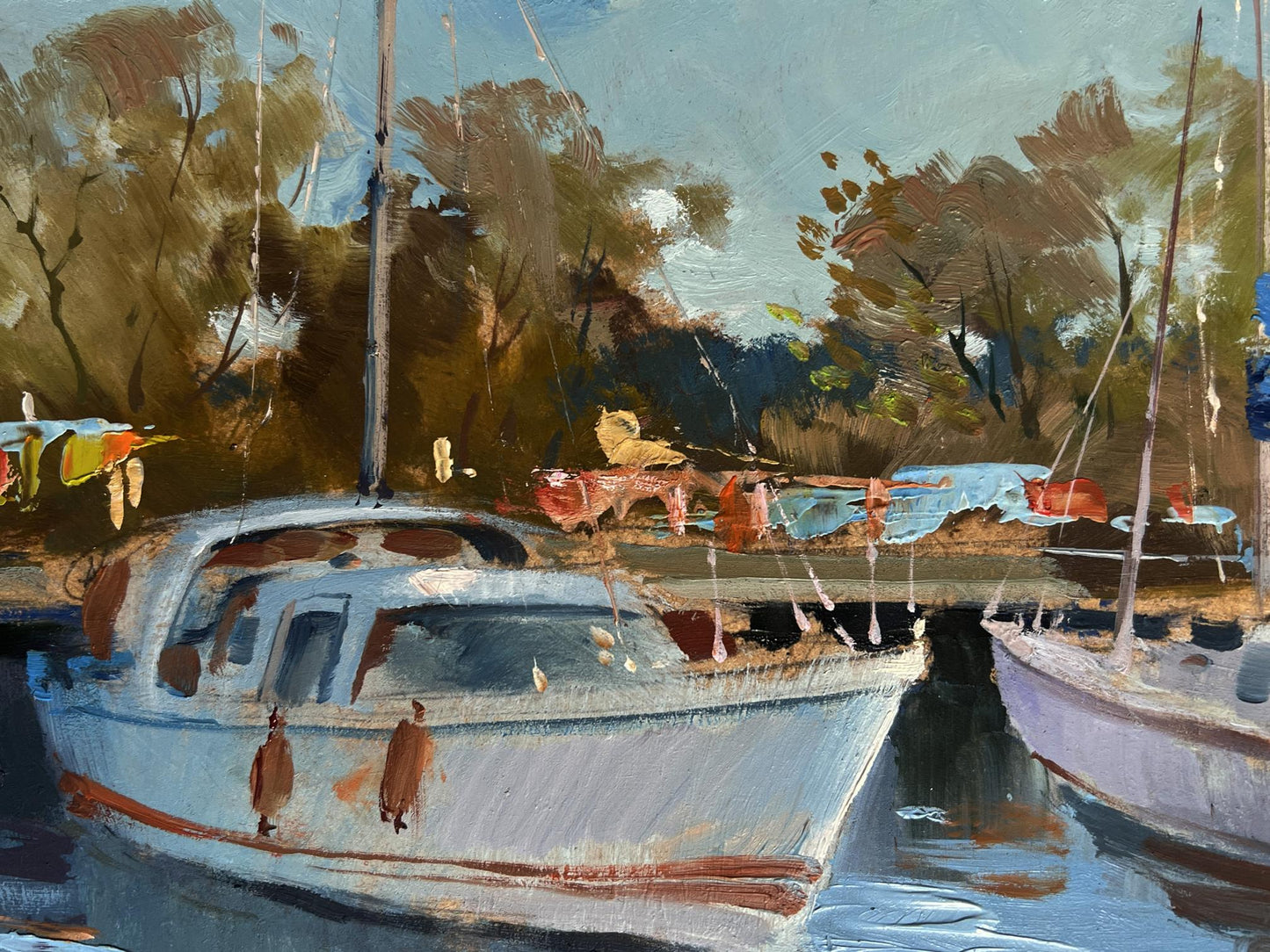 Oil painting of white sailboat with red hull stripe by Yuriy Suprunchuk