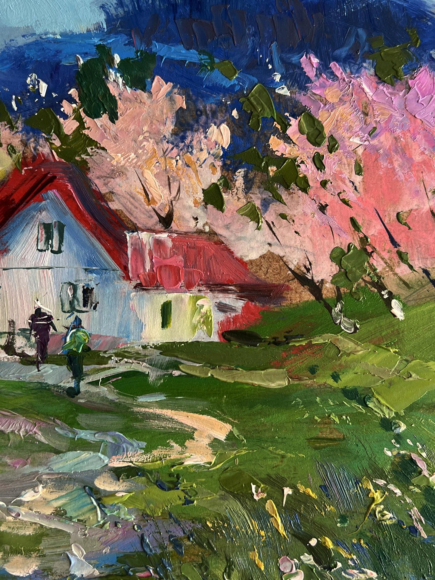 Vibrant impressionist oil painting by Yuriy Suprunchuk of white house with red roof among blooming pink trees