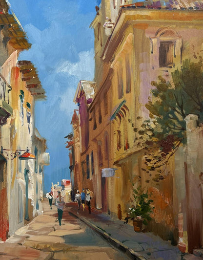 Oil painting by Yuriy Suprunchuk: warm ochre terracotta buildings in sunlit cobblestone alley