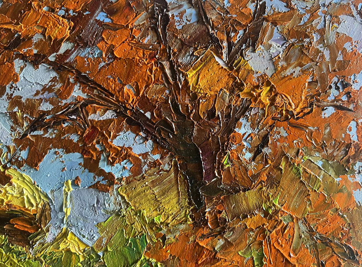 A textured, impressionistic painting of a tree with thick impasto brushstrokes in autumnal hues of orange, brown, and muted green against patches of blue.