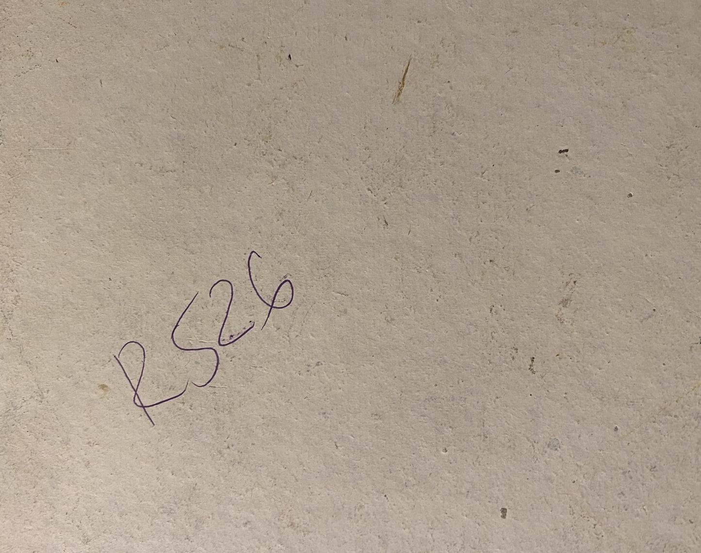 Back of Georgy Kolosovsky oil painting with handwritten rs26 on beige surface