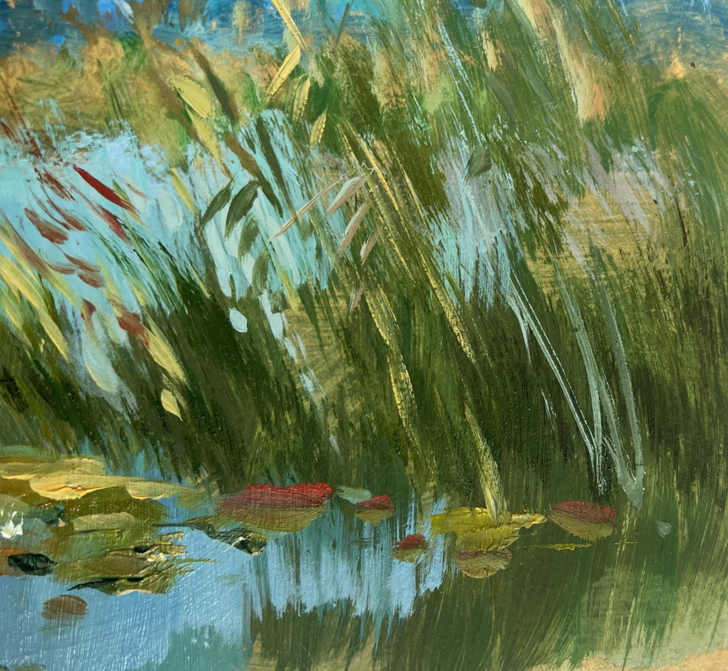 Vibrant impressionist oil painting by Yuriy Suprunchuk of green reeds and red lily pads on blue pond