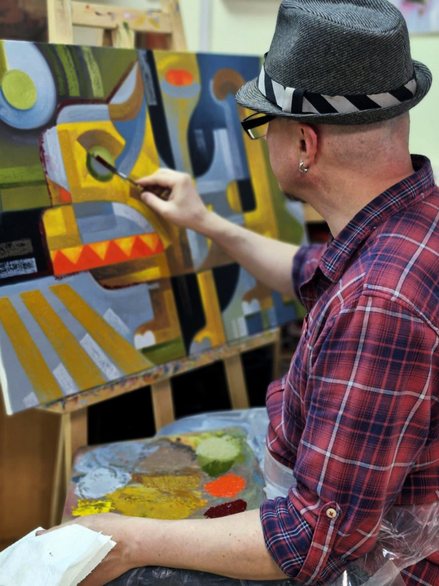 Man in gray fedora paints abstract Oil painting Near the crosswalk by Sergiy Voichenko