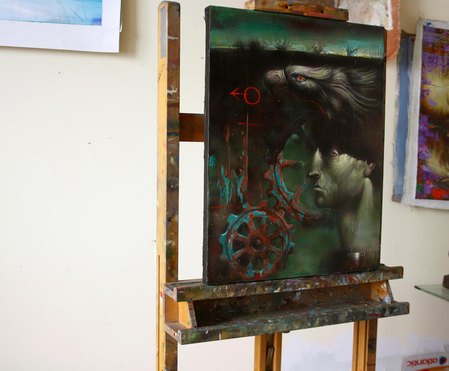 Oil painting Mechanics Alexander Dobrodiy: surreal face, eagle, gears on easel