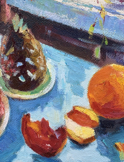 Oil painting by Boris Serdyuk: vibrant orange fruit and half on blue surface