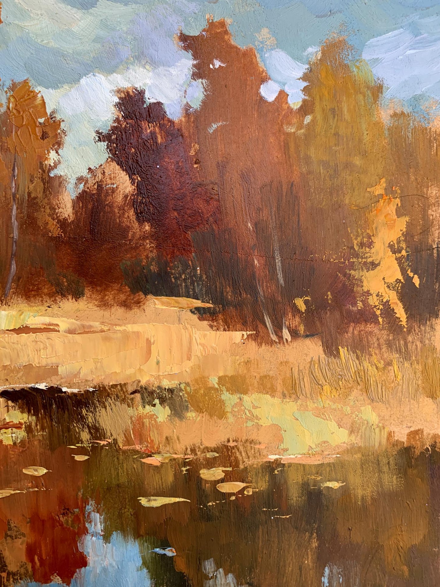 Oil painting by Yuriy Suprunchuk: golden autumn trees reflected in calm pond