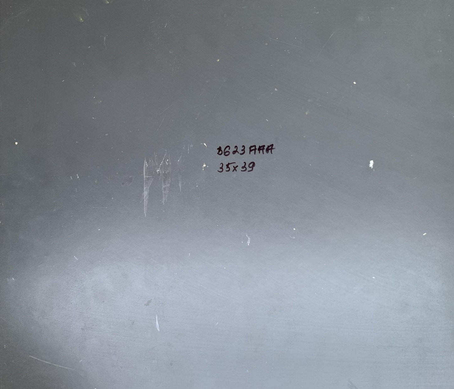 Back of Yuriy Suprunchuk oil painting with gray metallic surface, handwritten markings and scratches