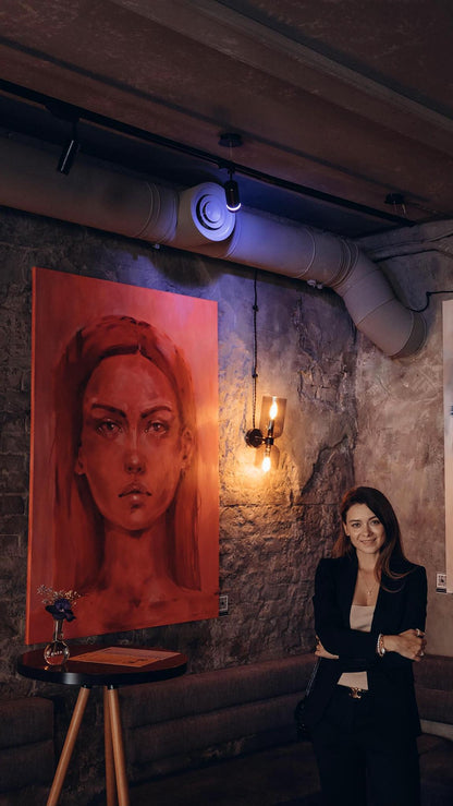 Striking red oil portrait of Doubt by Victoria Kagalovska on brick wall