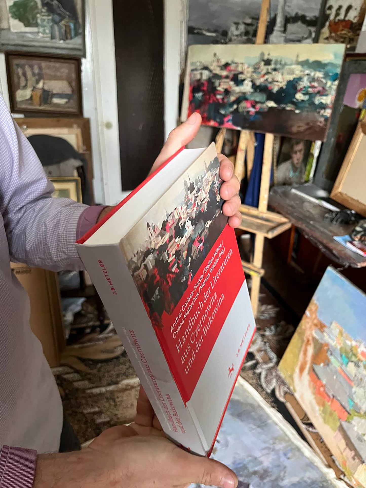 Red and white hardcover Oil painting Panorama of Chernivtsi book by Bohdan Makarenko