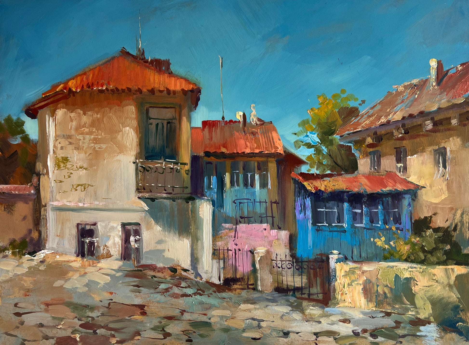 Vibrant blue and ochre houses on cobblestone street, Yuriy Suprunchuk fine art