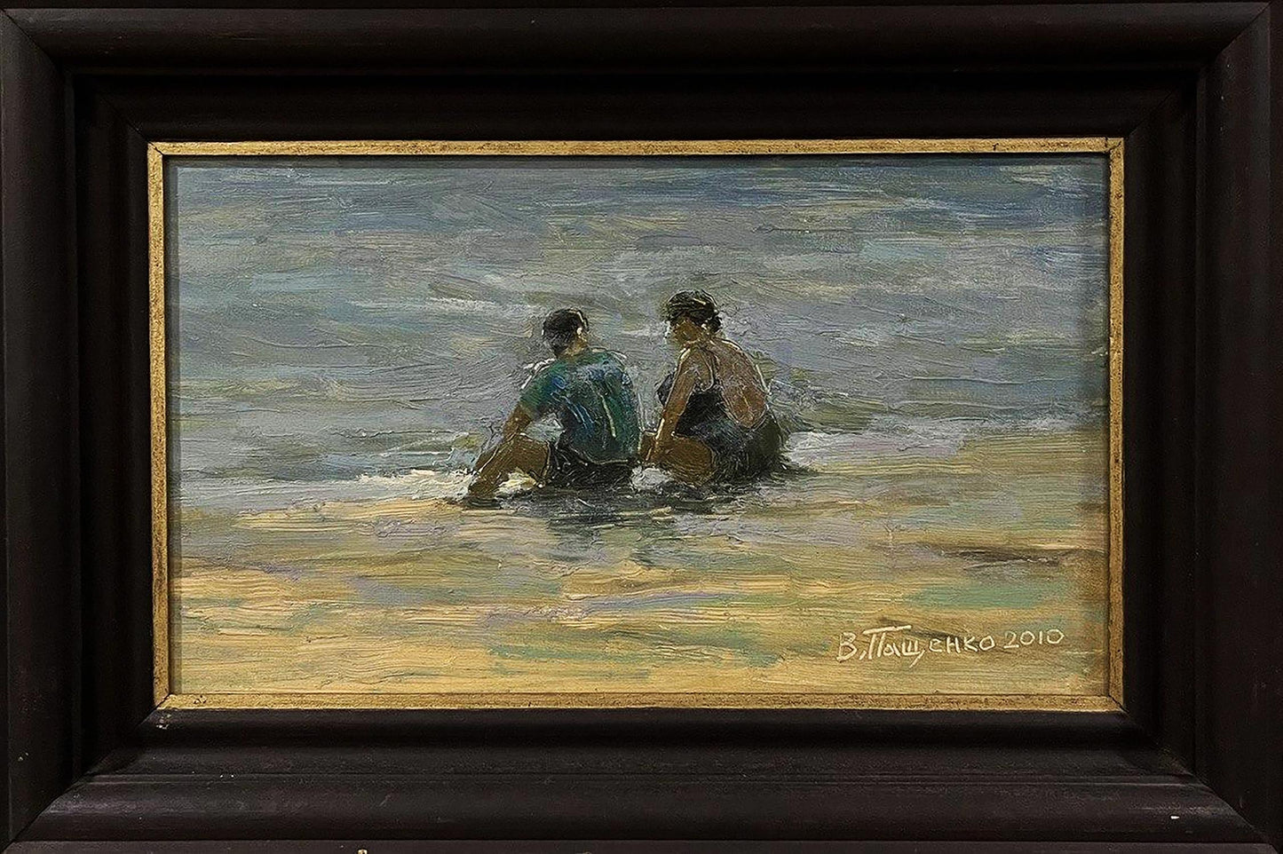 Framed oil painting of two figures in shallow ocean water by Volodymyr Pashchenko