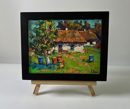 Oil painting Apiary in the Yard by Oksana Ivanyuk in black frame