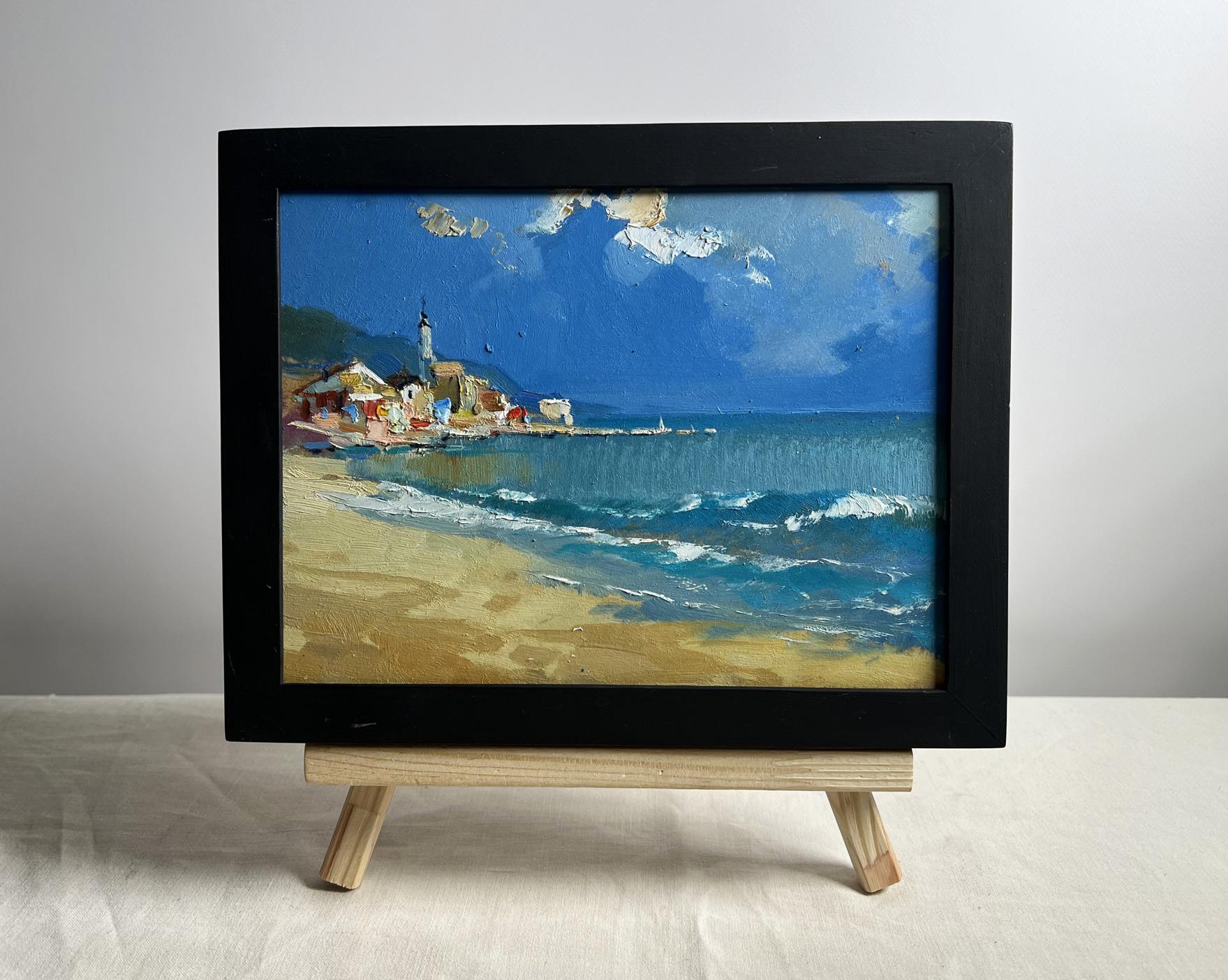 Framed oil painting of coastal village by Yuriy Suprunchuk, vibrant blues and golds