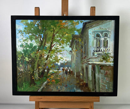 Framed oil painting of sunlit city street by Yuriy Suprunchuk