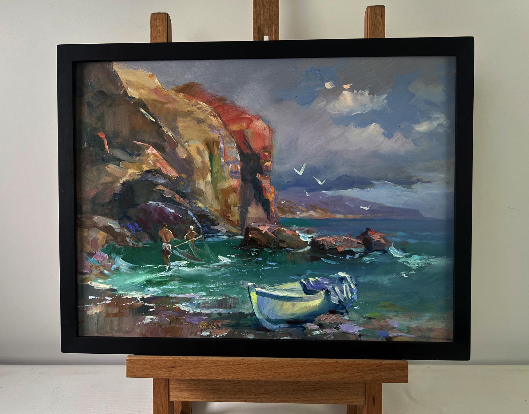 Framed oil painting by Yuriy Suprunchuk of fishermen pulling nets by coastal cliffs