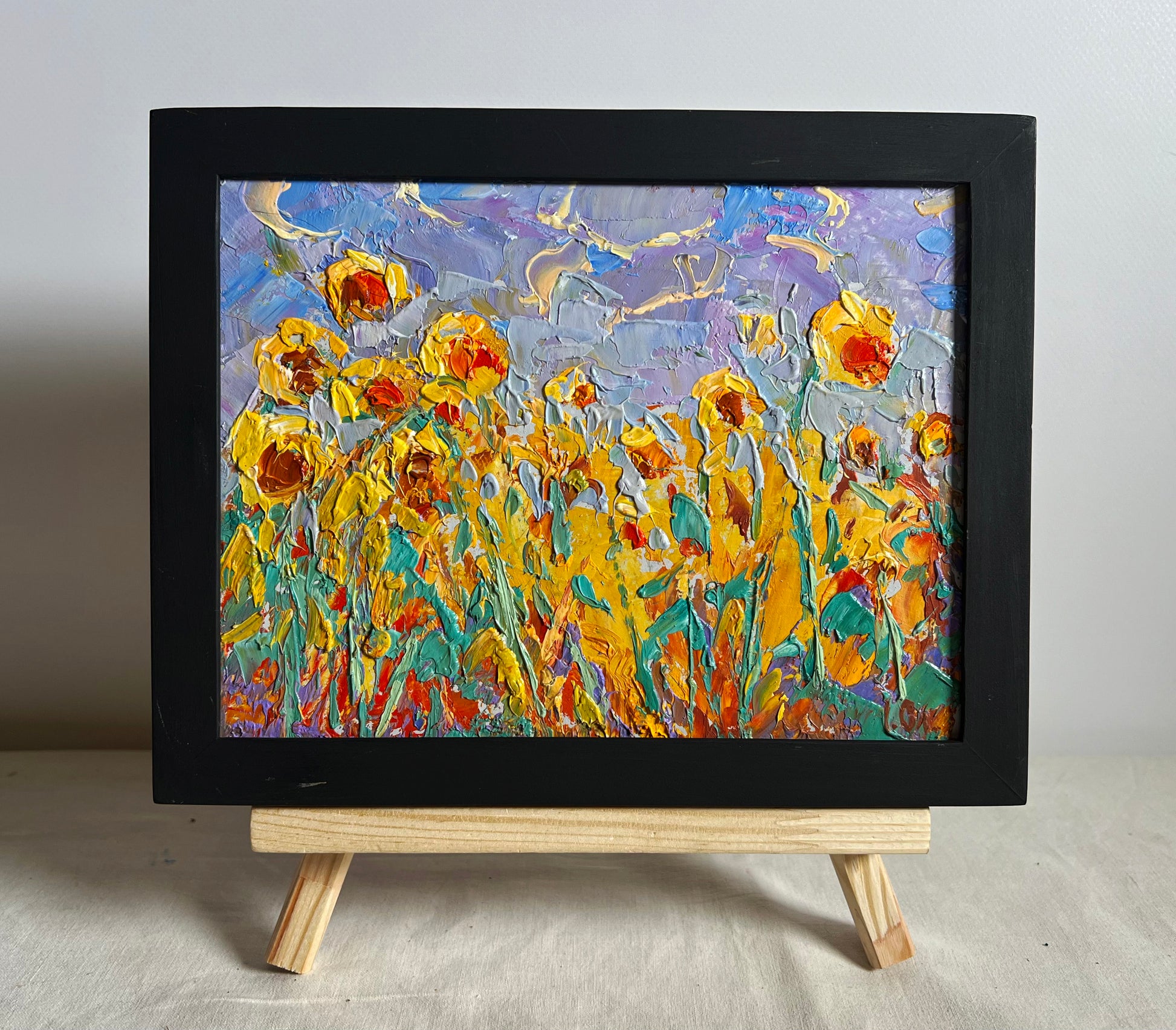 Oil painting To the sky by Oleksiy Ivanyuk: vibrant sunflowers in black frame