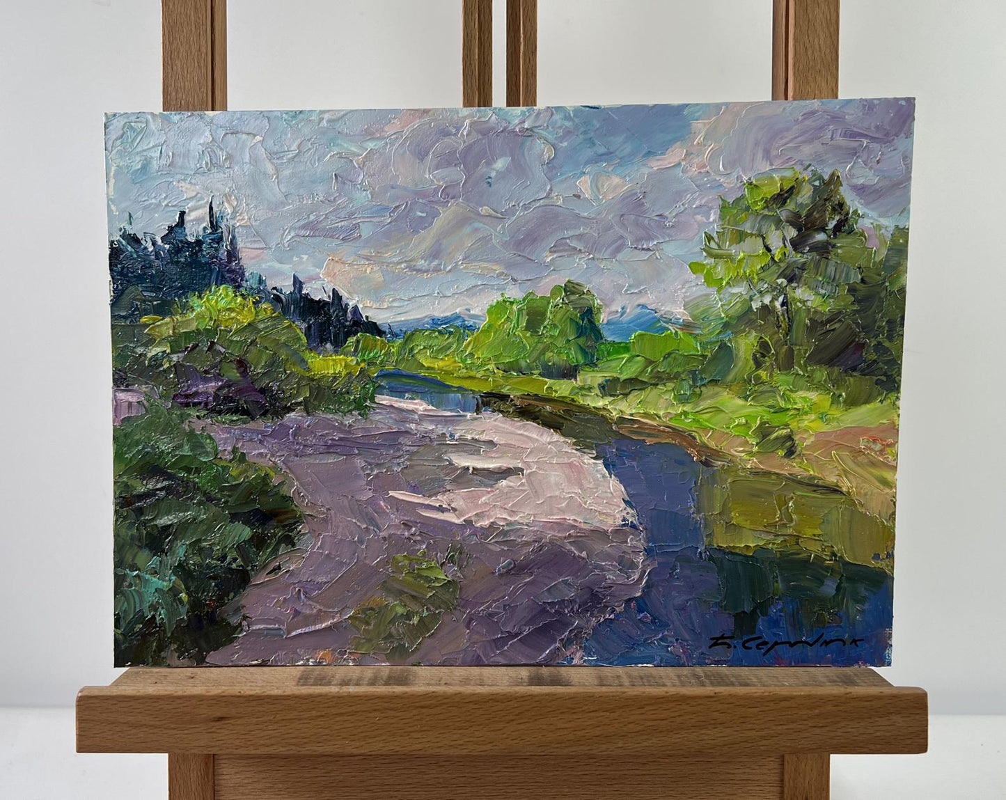 Textured impressionist oil painting by Boris Serdyuk: winding river, lush greenery, sand underfoot, dramatic clouds on canvas