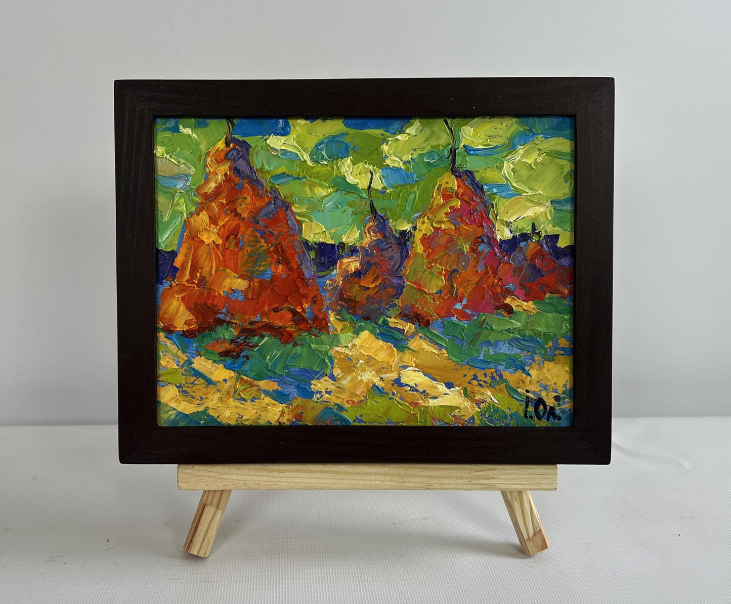 Oil painting of haystacks in field by Oleksiy Ivanyuk in black frame