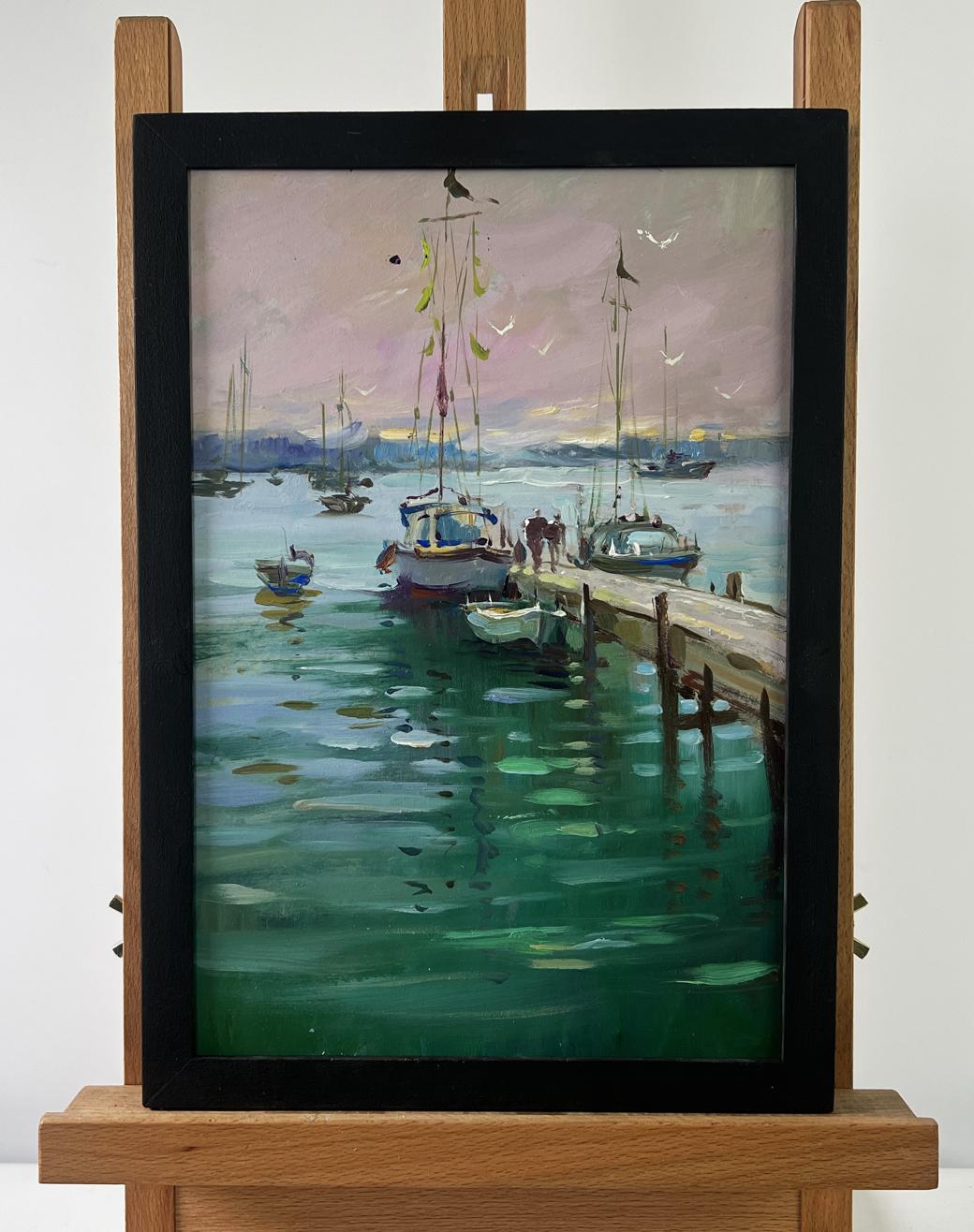 Oil painting Where boats sleep at the pier by Yuriy Suprunchuk in black frame on easel