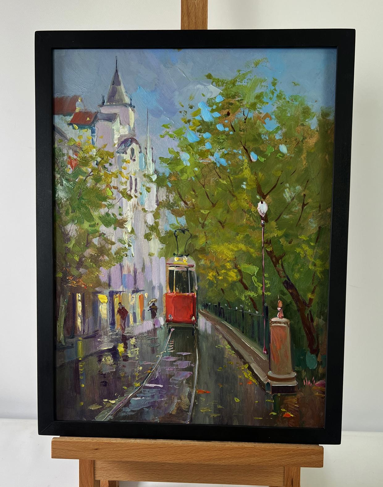 Framed oil painting of red city tram by Yuri Suprunchuk on wet street