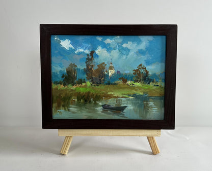 Framed oil painting of lonely boat among reeds by Yuriy Suprunchuk