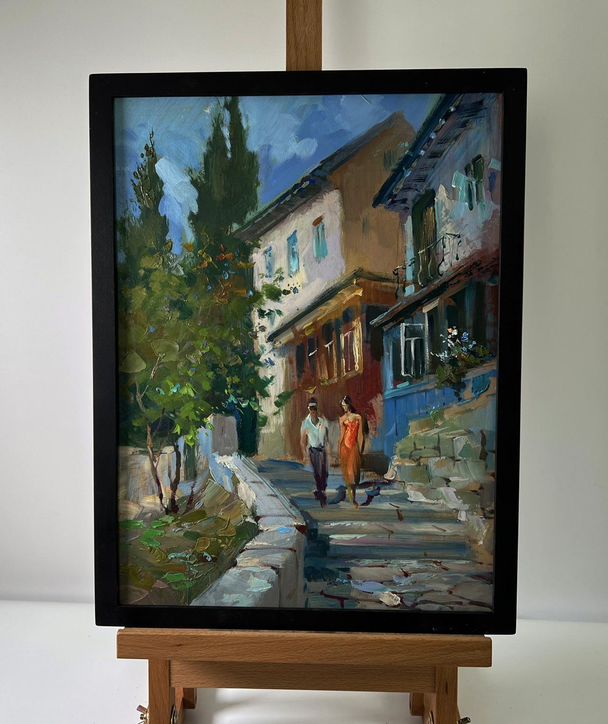 Framed oil painting by Yuriy Suprunchuk of couple on sunlit cobblestone street