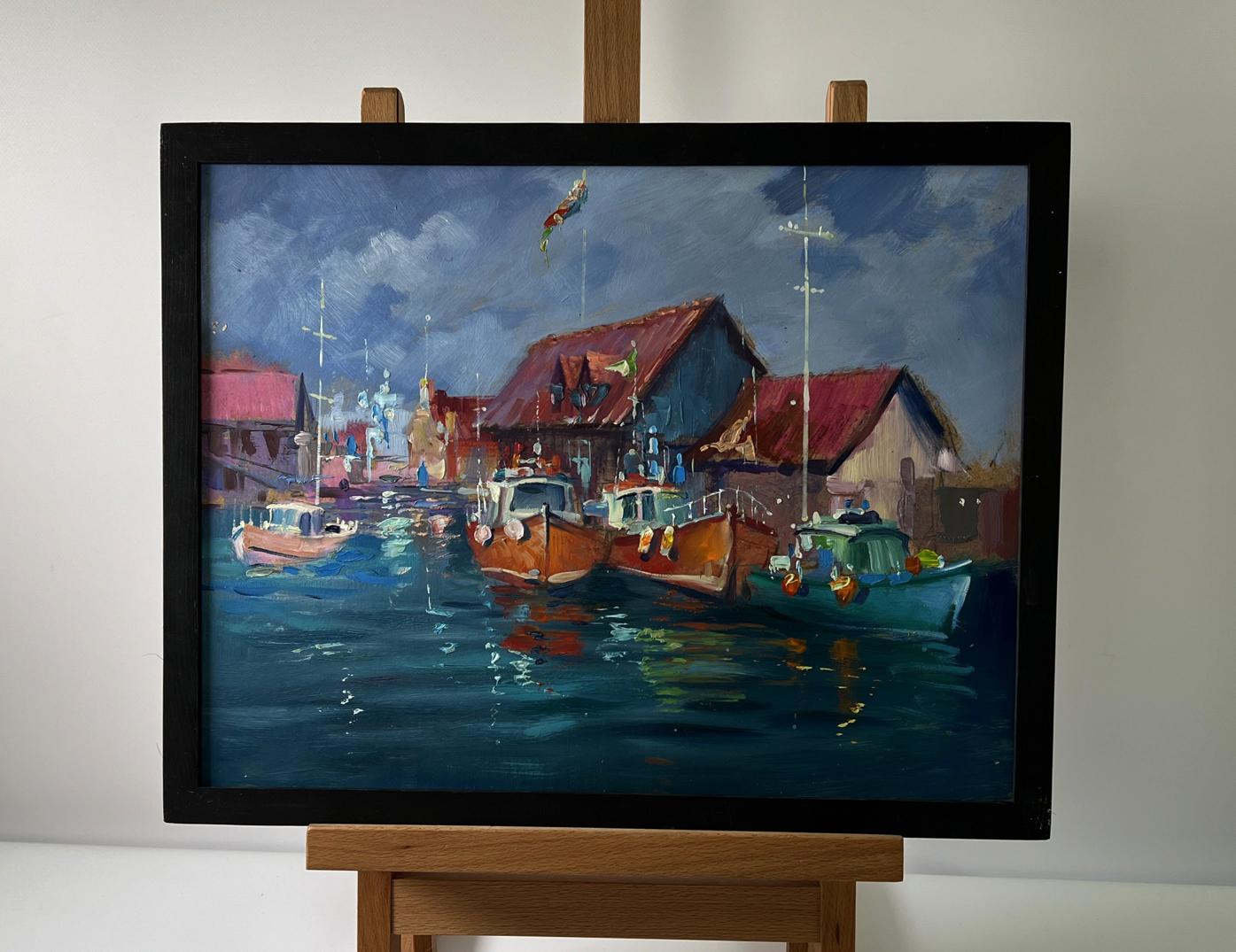 Oil painting City on the Water by Yuriy Suprunchuk in black frame on easel