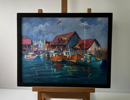 Oil painting City on the Water by Yuriy Suprunchuk in black frame on easel