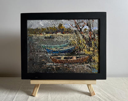 Oil painting Autumn melancholy by Oksana Ivanyuk, textured boats on shoreline in black frame
