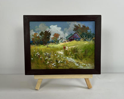 Framed oil painting by Yuriy Suprunchuk of couple in pastoral field