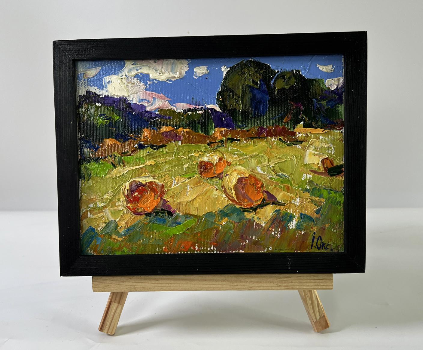 Vibrant oil painting Haystacks in a field by Oksana Ivanyuk on wooden easel
