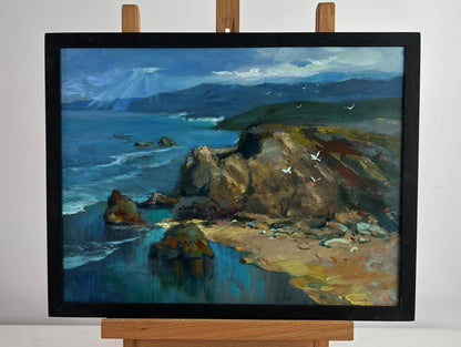 Framed oil painting of coastal cliffs, waves, seagulls and sunlight through clouds by Yuriy Suprunchuk