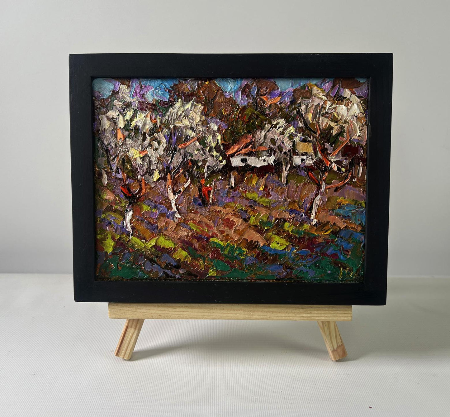 Vibrant oil painting of gardens in bloom with white horses by Oleksiy Ivanyuk