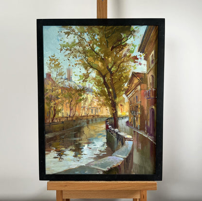 Framed oil painting of serene city alley with river by Yuriy Suprunchuk