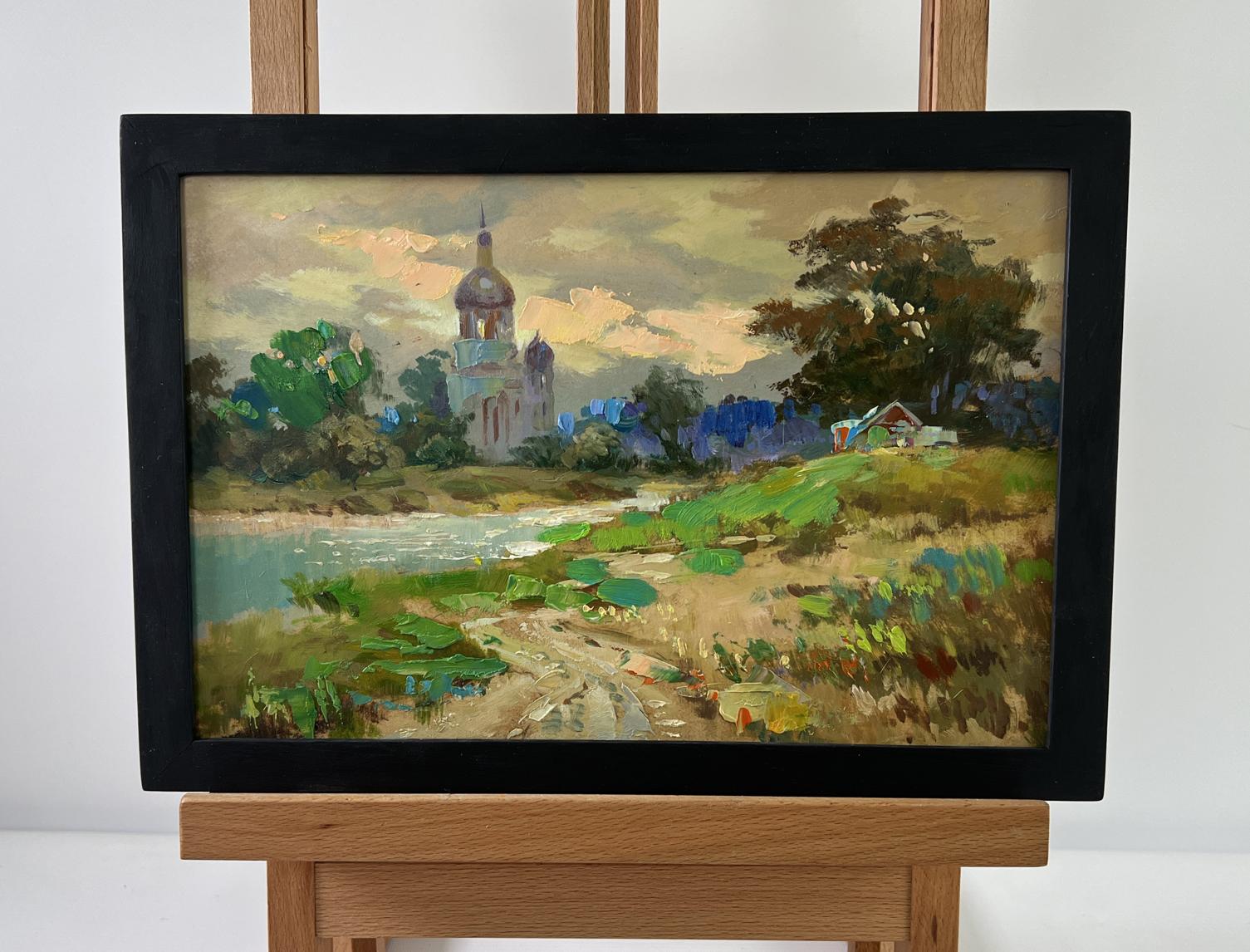 Framed oil painting of church over river by Yuriy Suprunchuk