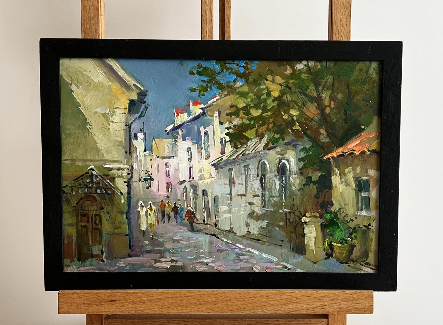 Framed oil painting of Yuriy Suprunchuks bustling old city street