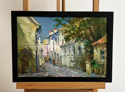 Framed oil painting of Yuriy Suprunchuks bustling old city street