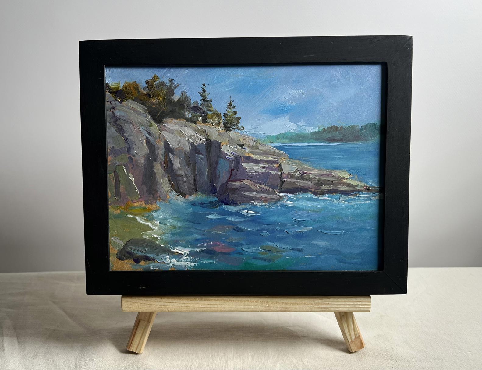Black-framed oil painting Cloudy day at sea by Yuriy Suprunchuk on wooden easel