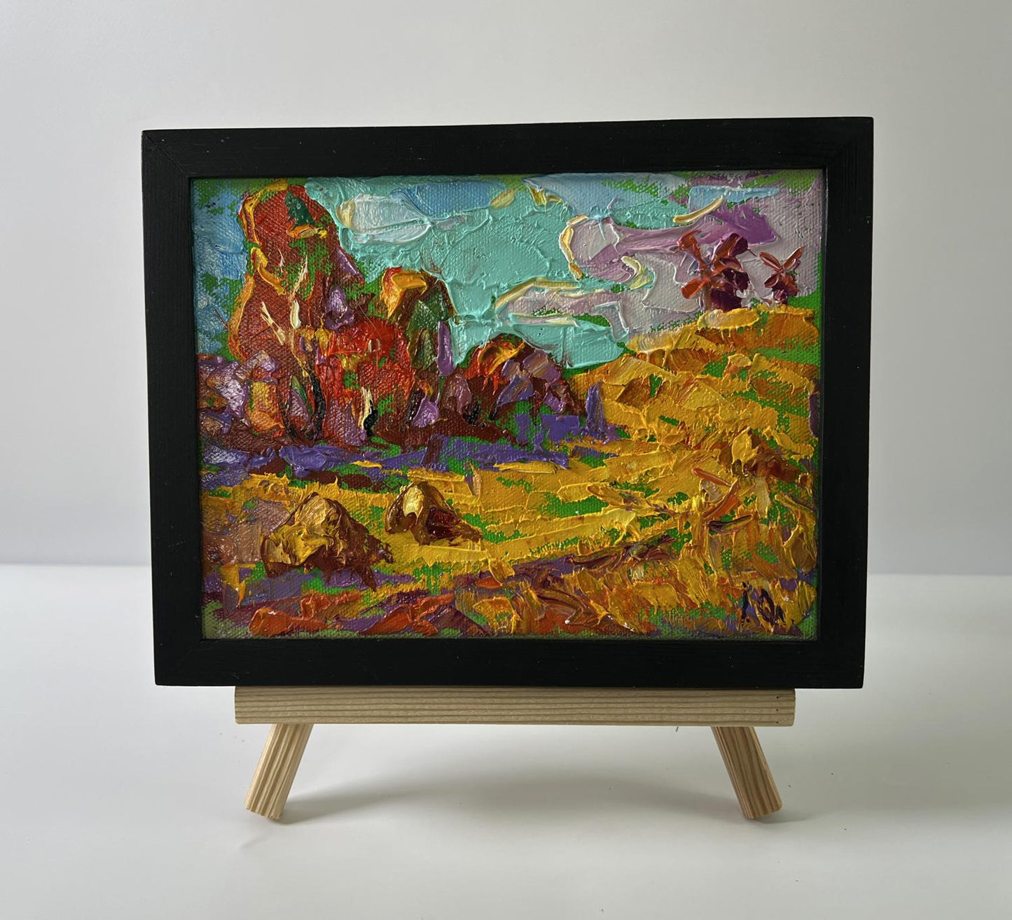 Oil painting Autumn nature by Oleksiy Ivanyuk: colorful desert rocks and windmills