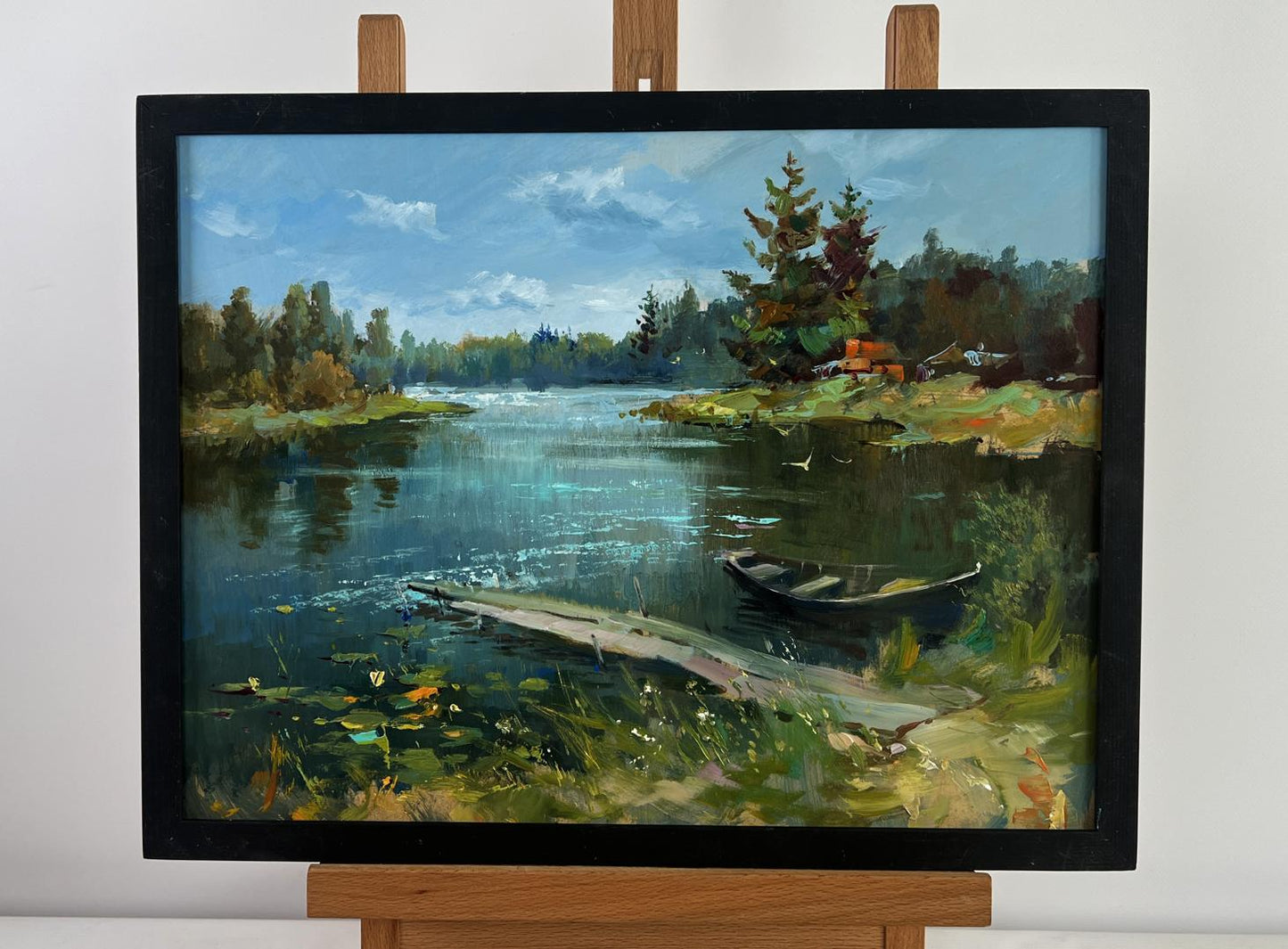 Framed oil painting of lonely boat by river by Yuriy Suprunchuk