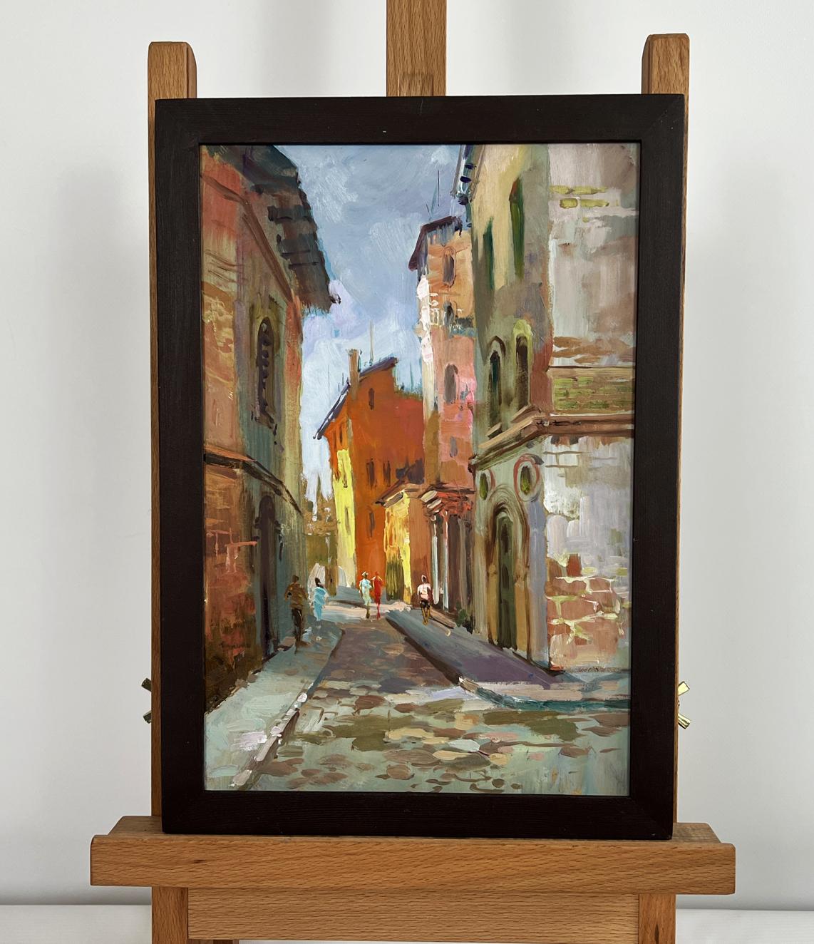 Framed oil painting of sunlit cobblestone street by Yuriy Suprunchuk
