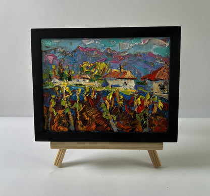 Vibrant textured oil painting of Oleksiy Ivanyuk Clean village air in black frame on easel