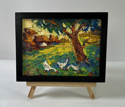 Vibrant oil painting In the Shade of the Trees by Oksana Ivanyuk, geese in field on easel