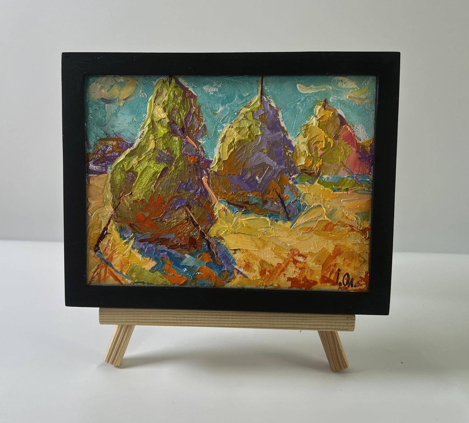 Oil painting of colorful haystacks in field by Oleksiy Ivanyuk in black frame